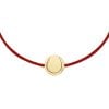 14 k yellow gold Tennis Ball pendant on string bracelet